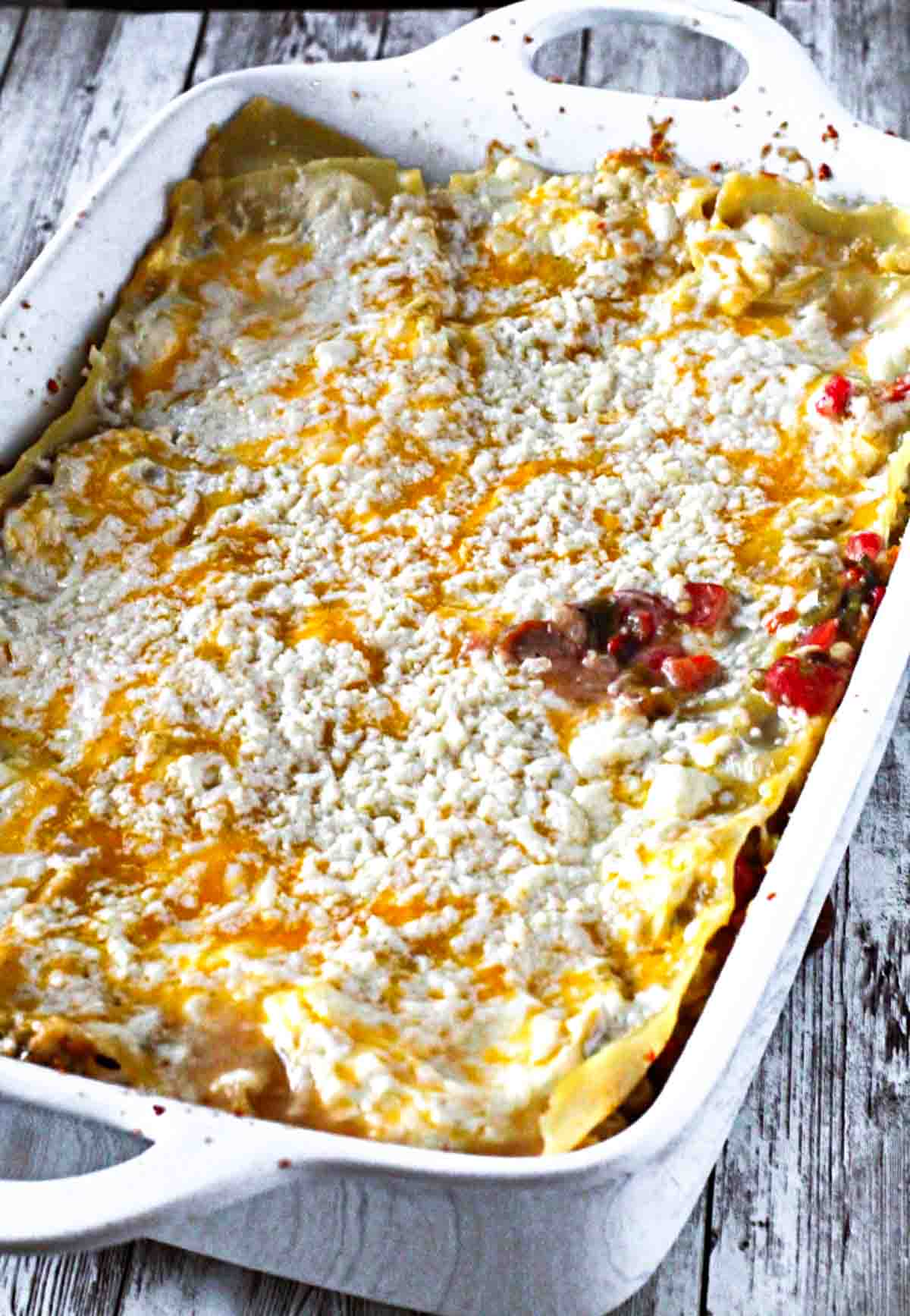Green chili chicken lasagna in a casserole dish.