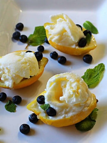 lemon lush dessert served in lemon shells garnished with blueberries