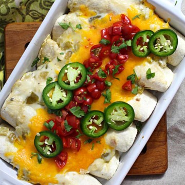 Breakfast burritos in a casserole dish filled with avocados and scrambled eggs.