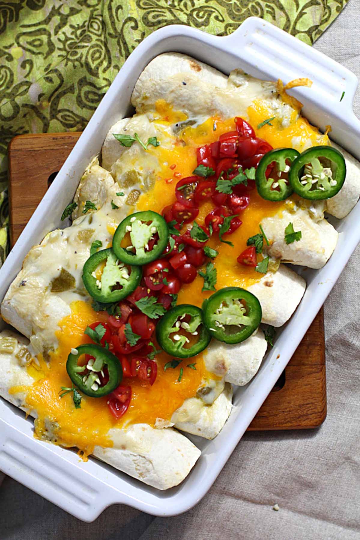 Breakfast burritos in a casserole dish filled with avocados and scrambled eggs.