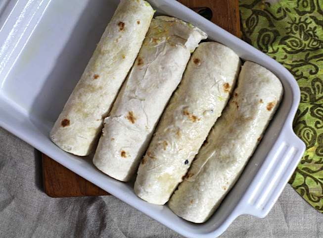 Avocado and scrambled eggs burritos in an oven proof baking dish