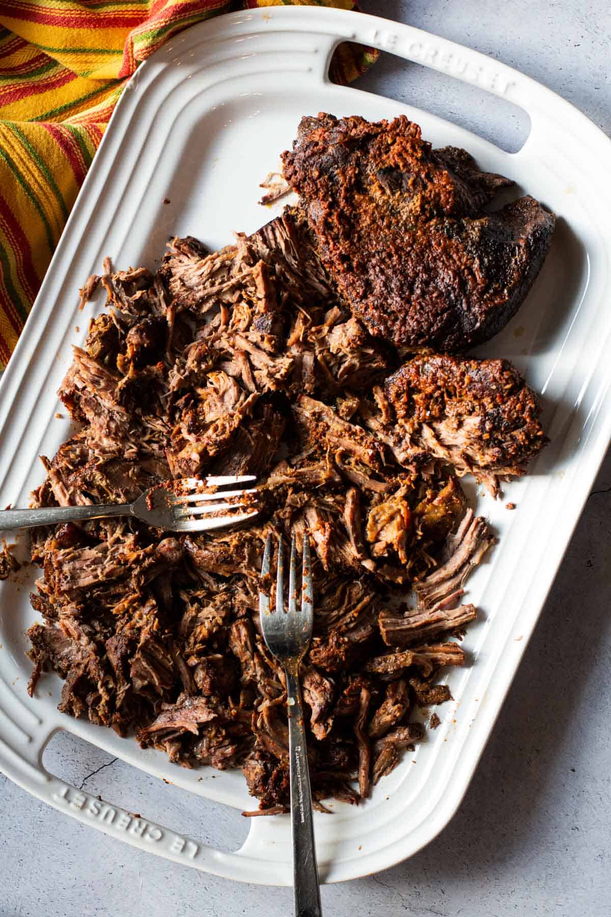 Shredding a chuck roast to make roast beef tacos.