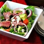 Chipotle steak salad in a square white bowl.