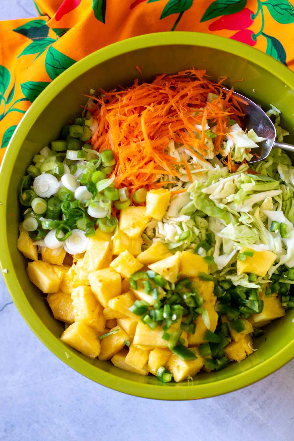 Ingredients to make Hawaiian cole slaw in a large bowl.