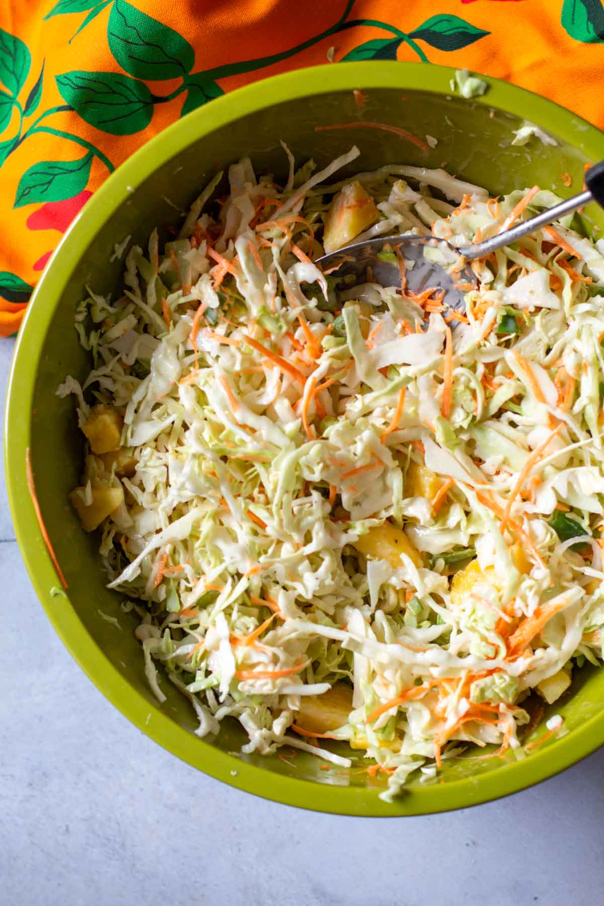 Mixing ingredients to make Hawaiian coleslaw.