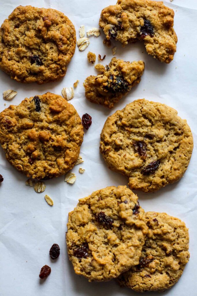 Oatmeal Cookies with raisins and pecans on parchment paper.