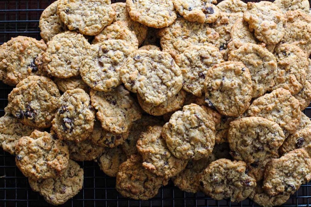 3 dozen oatmeal raisin cookies cooling on a wire rack.