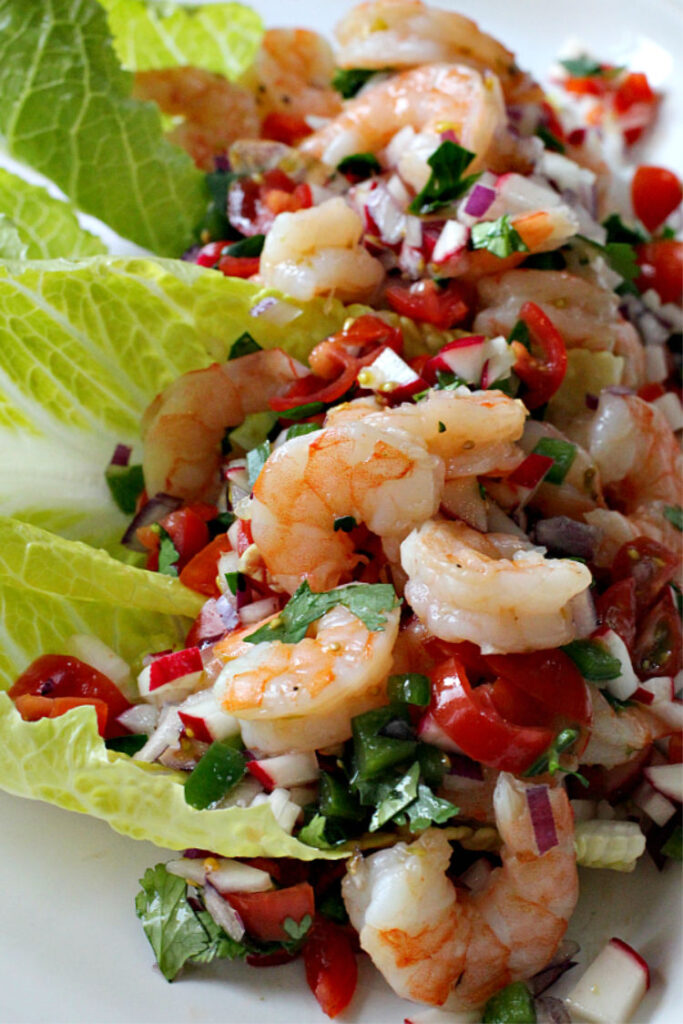 Shrimp and mixed vegetables served on romaine lettuce leaves.