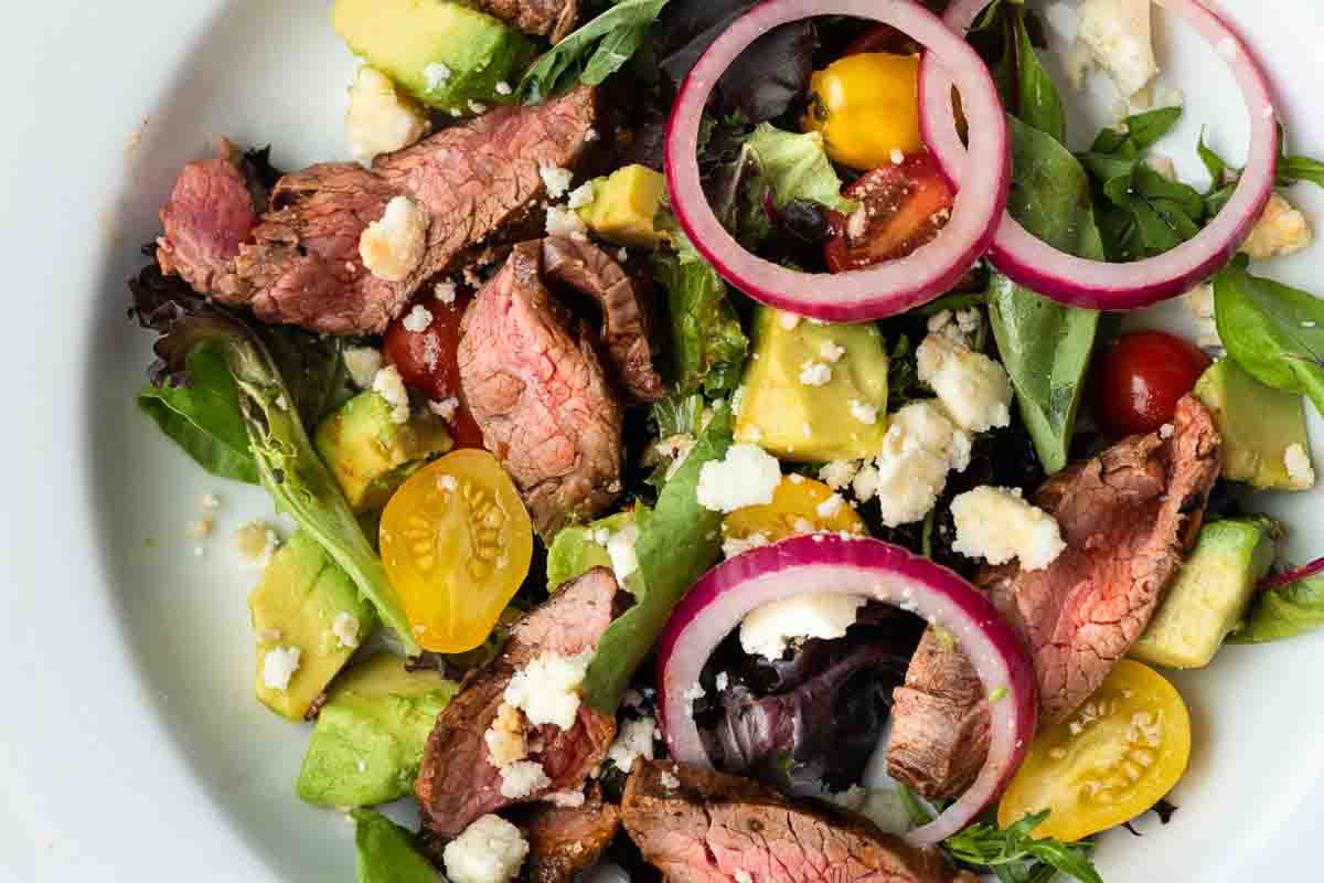 Honey Chipotle Skirt Steak Salad in a wide white salad bowl.