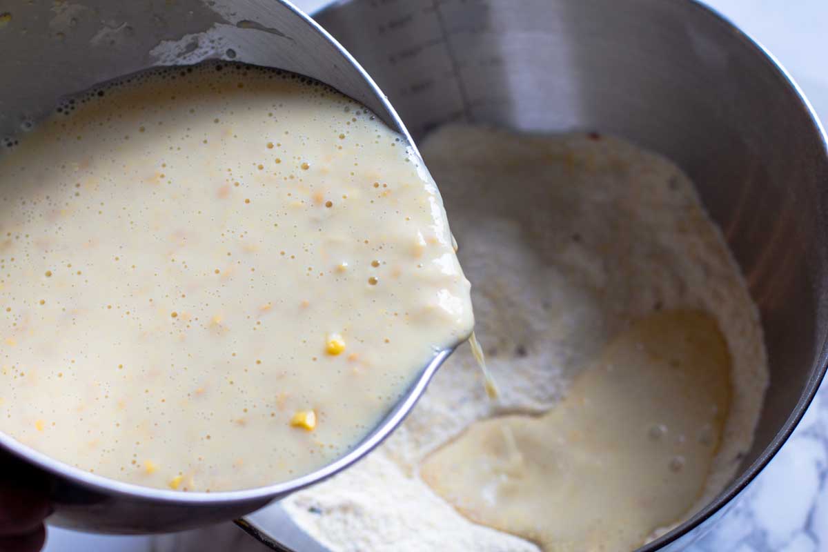 Adding wet ingredients to dry ingredients for muffins