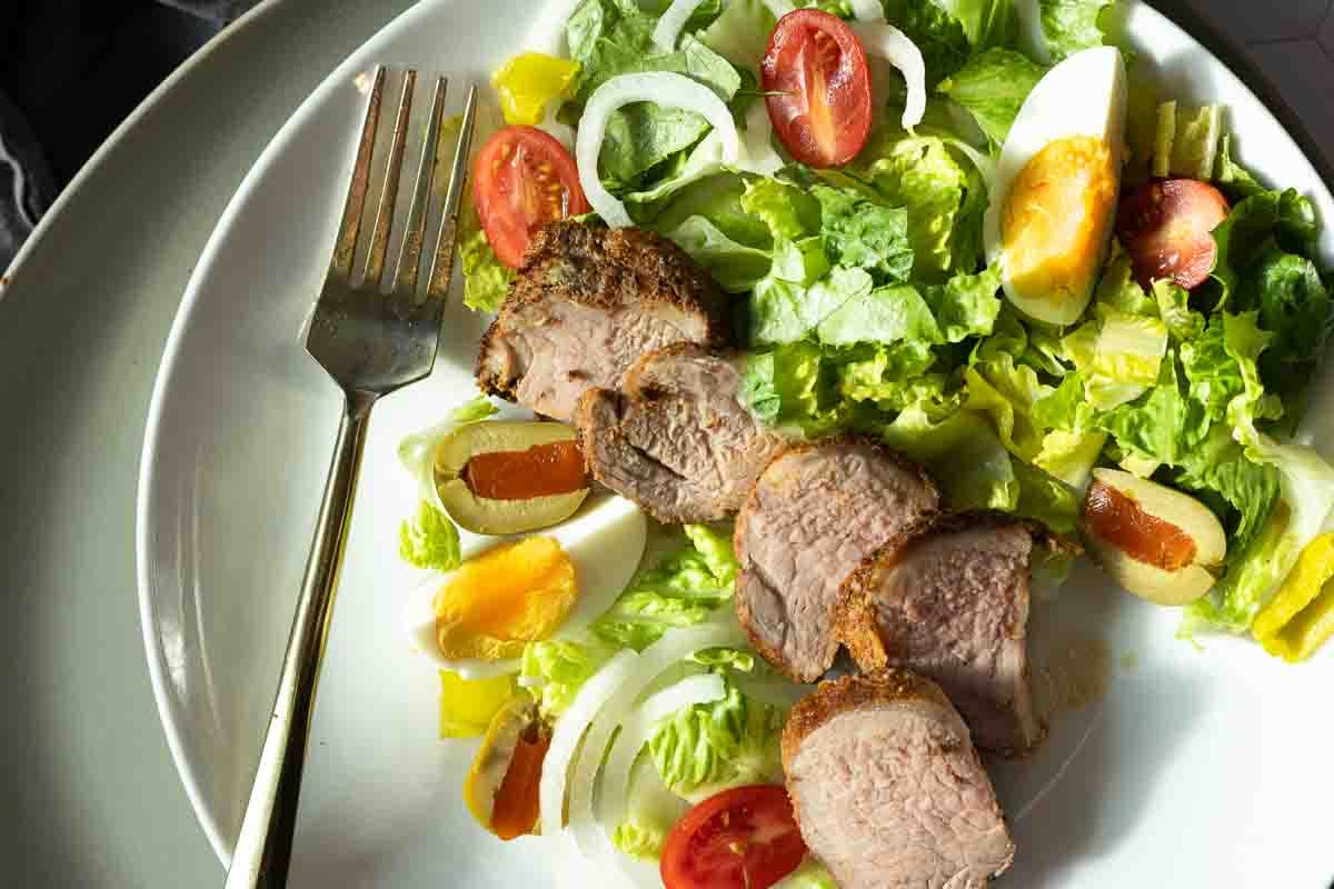 Oven baked pork tenderloin served with a tossed salad.
