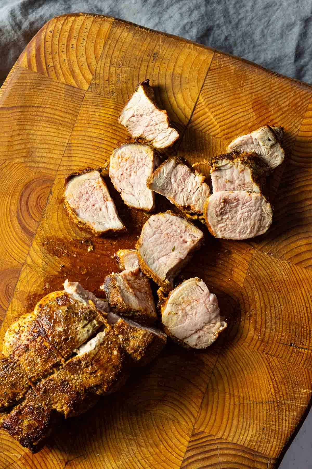 Slicing oven baked pork tenderloin for serving.