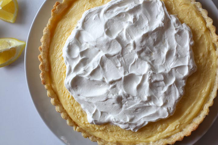 Lemon tart topped with homemade whipped cream