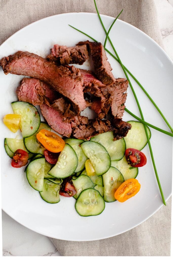 Flank steak marinade recipe with orange and ginger. Served with Asian pickled cucumbers.