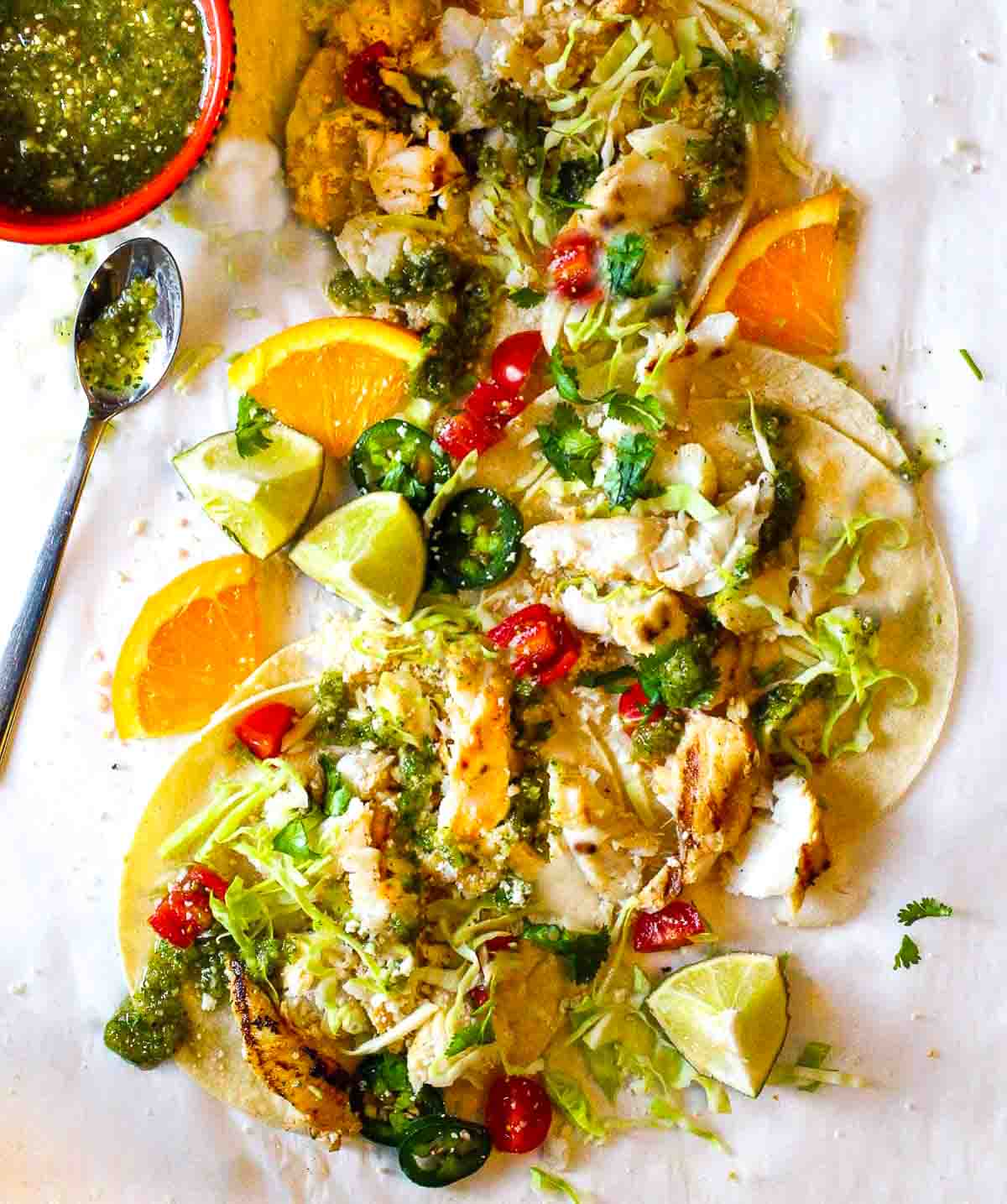 Fish tacos with cod on a white plate.