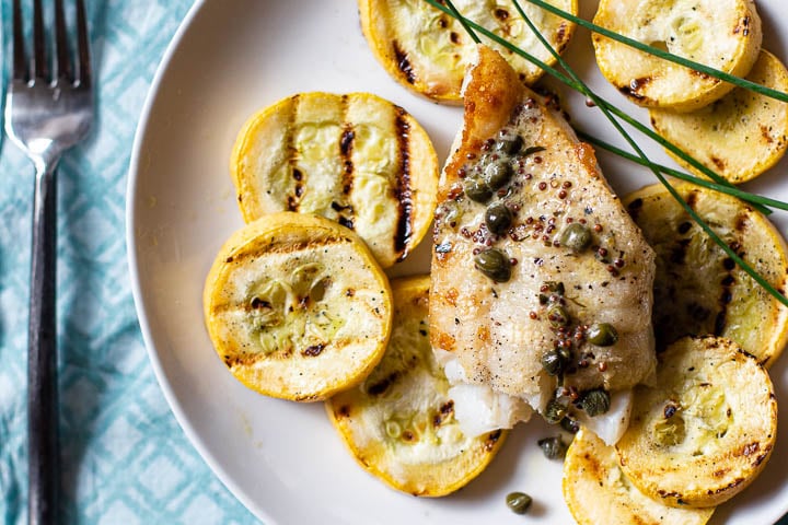 Pan fried cod served over grilled Summer Squash with a mustard caper cream sauce.