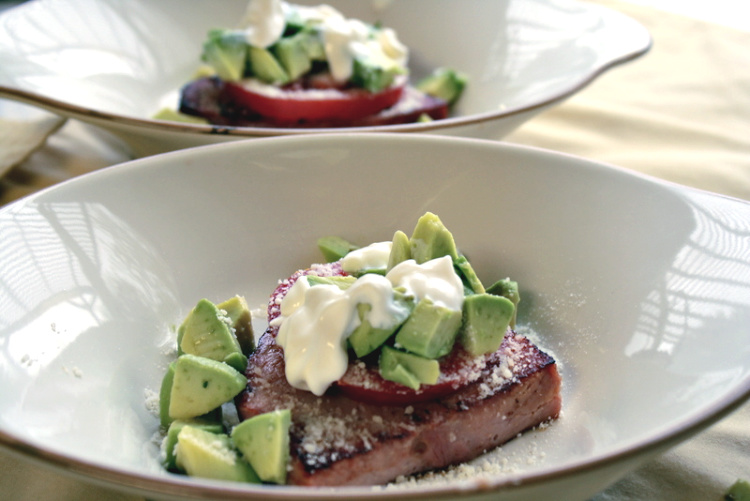 Toast topped with fresh sliced tomato, chopped avocado and sour cream