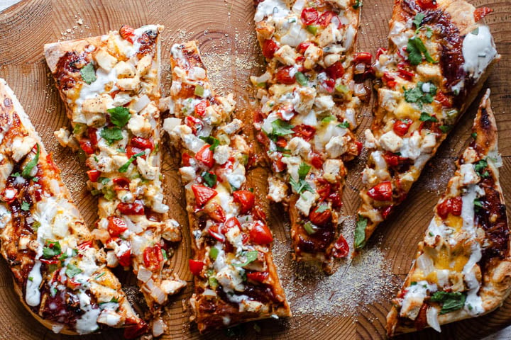 BBQ sauce Chicken pizza with jalapenos cilantro tomatoes and drizzled with ranch dressing.