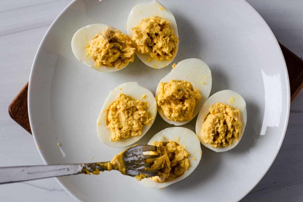 Filling deviled eggs with a fork