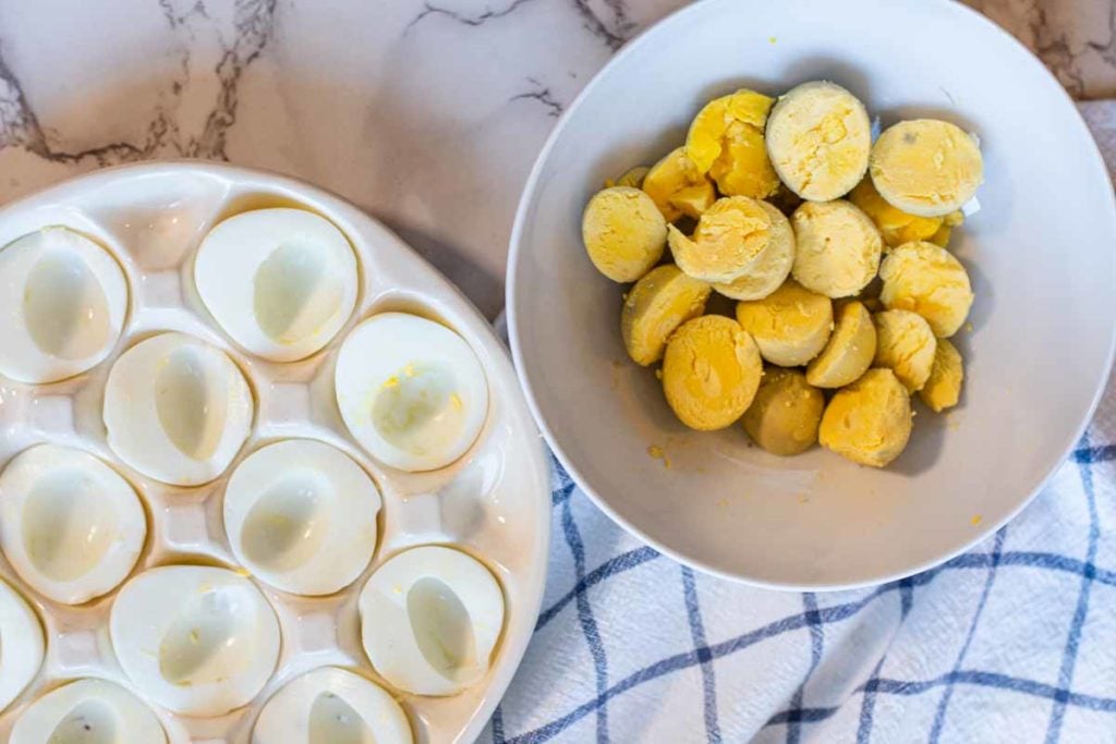 separating cooked egg yolks from egg whites to make deviled eggs