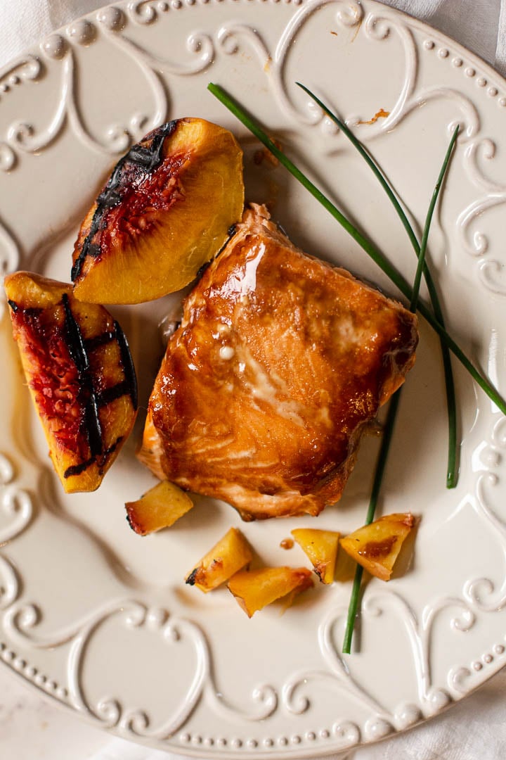 Salmon filet glazed with Teriyaki auce with grilled peaches and chives