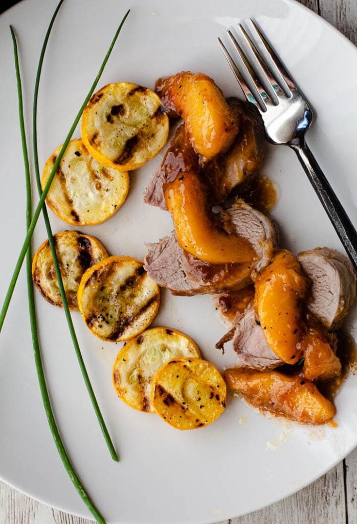 pork tenderloin medallions with peach bourbon sauce and grilled summer squash