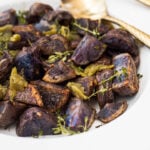 Purple roasted potatoes with garlic, thyme and green chile peppers