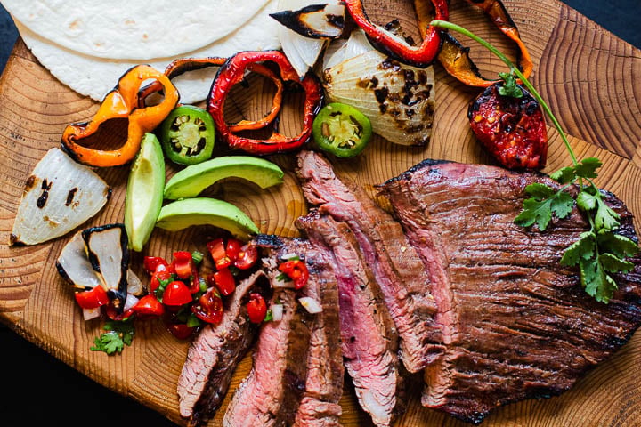 Flank steak fajitas with grilled vegetables and flour tortillas