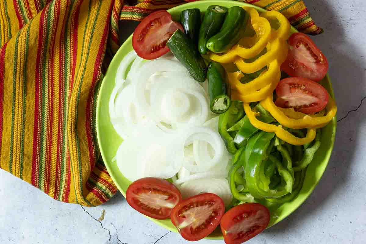 Sliced vegetables to serve with flank steak fajitas.