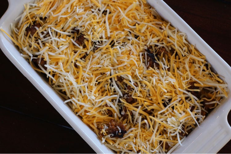 Adding shredded cheese to a Mexican breakfast casserole