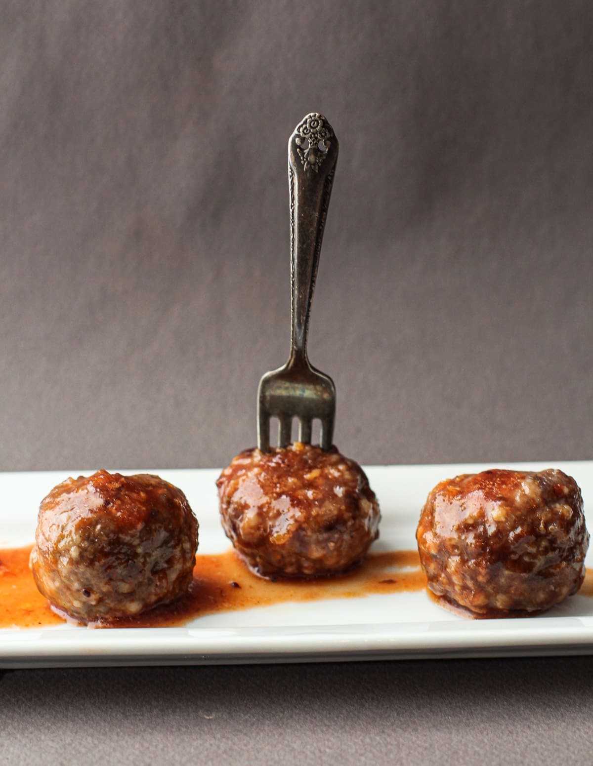 Sriracha Cranberry Meatballs served on a white plate.