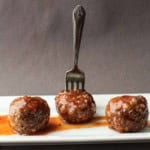 Honey sriracha meatballs served on a white platter.