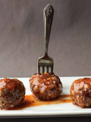 Honey sriracha meatballs served on a white platter.