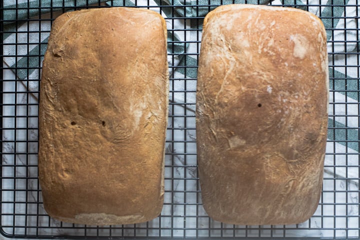 2 loaves of molasses bread cooling on rack