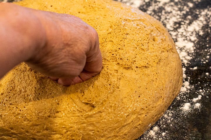 punching down oatmeal bread