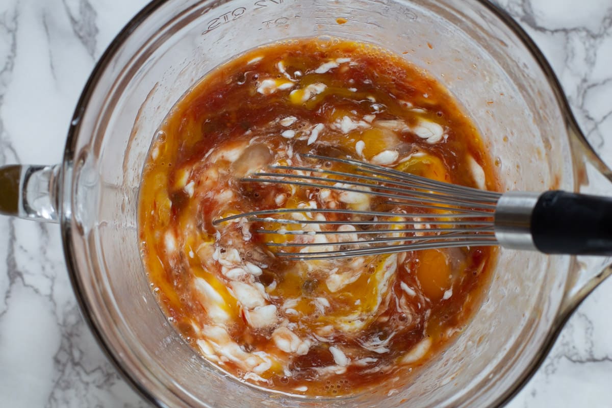 Mixing together egg custard for Mexican breakfast casserole