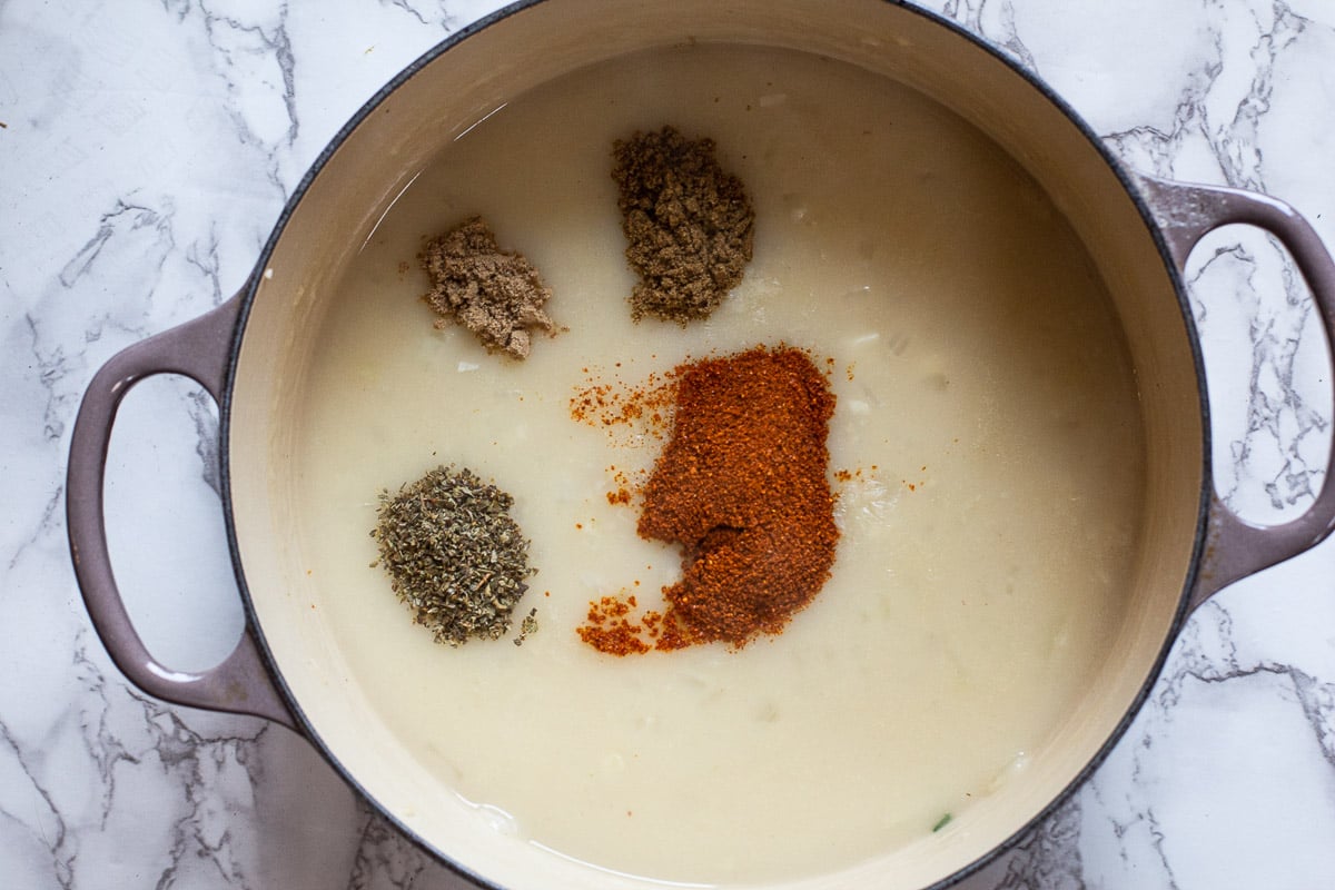 Adding spices to gravy for carne adovada