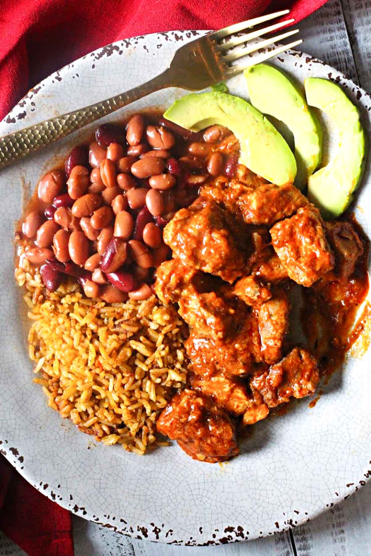 Carne adovada served with rice and beans.
