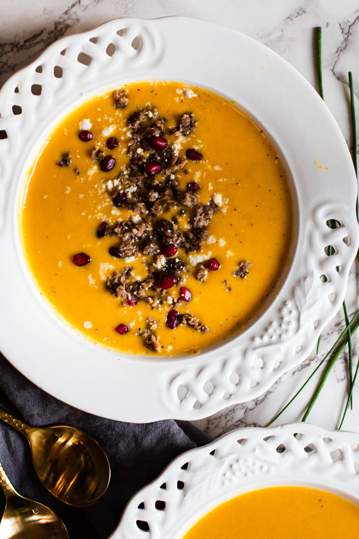 Curried butternut squash soup topped with Jimmy Dean Sausage, pomegranate seeds and cotija cheese