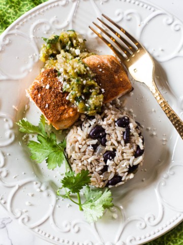 Mexican salmon topped with salsa verde with a side of black beans and rice
