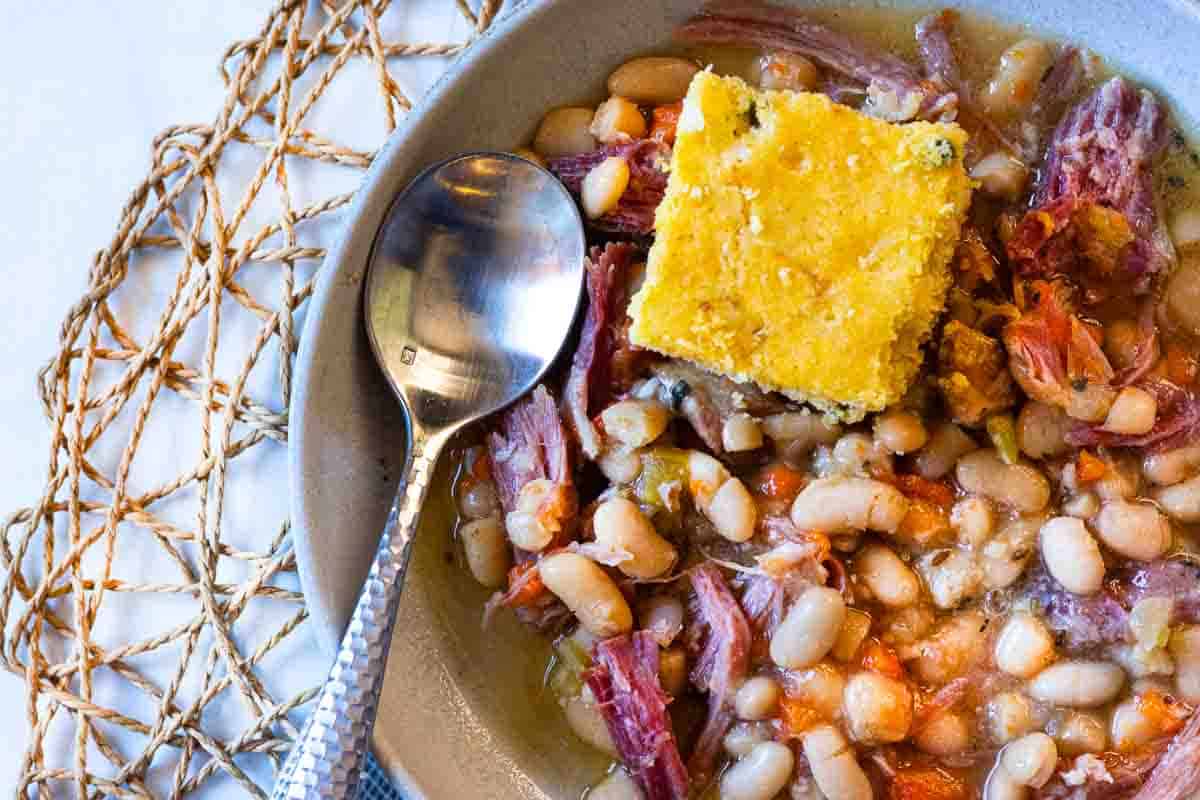 Crockpot ham and beans served with cornbread.