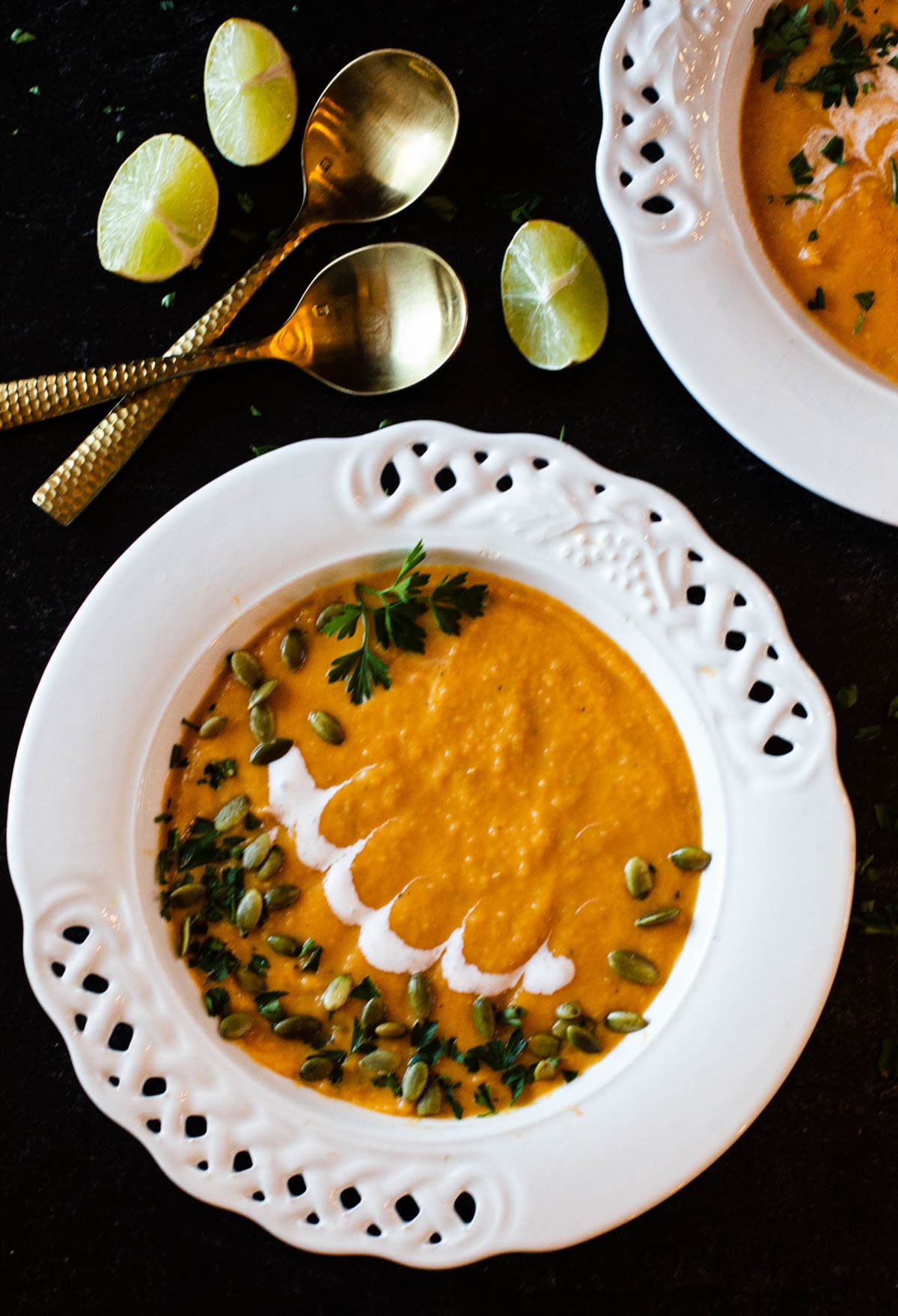 Chipotle Sweet Potato Soup garnished with pepita seeds, cilantro and sour cream. 