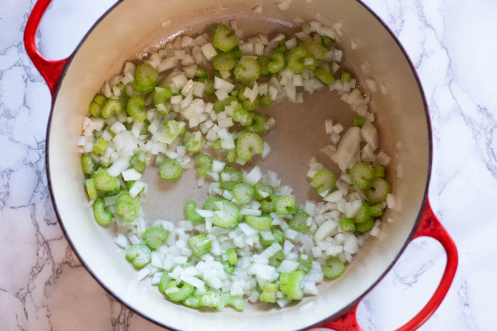 Sauteeing onion and celery to make spicy sweet potato soup