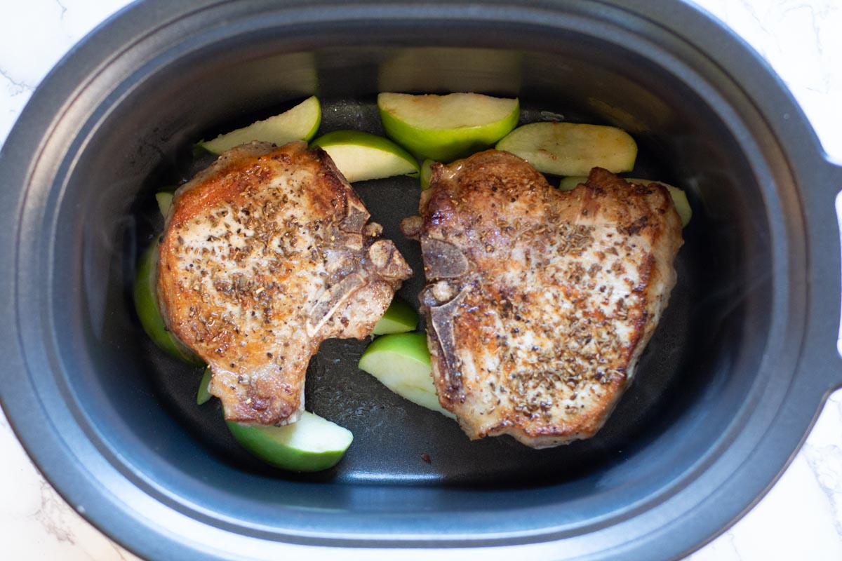 Adding thick cut bone in pork chops to crockpot over apples
