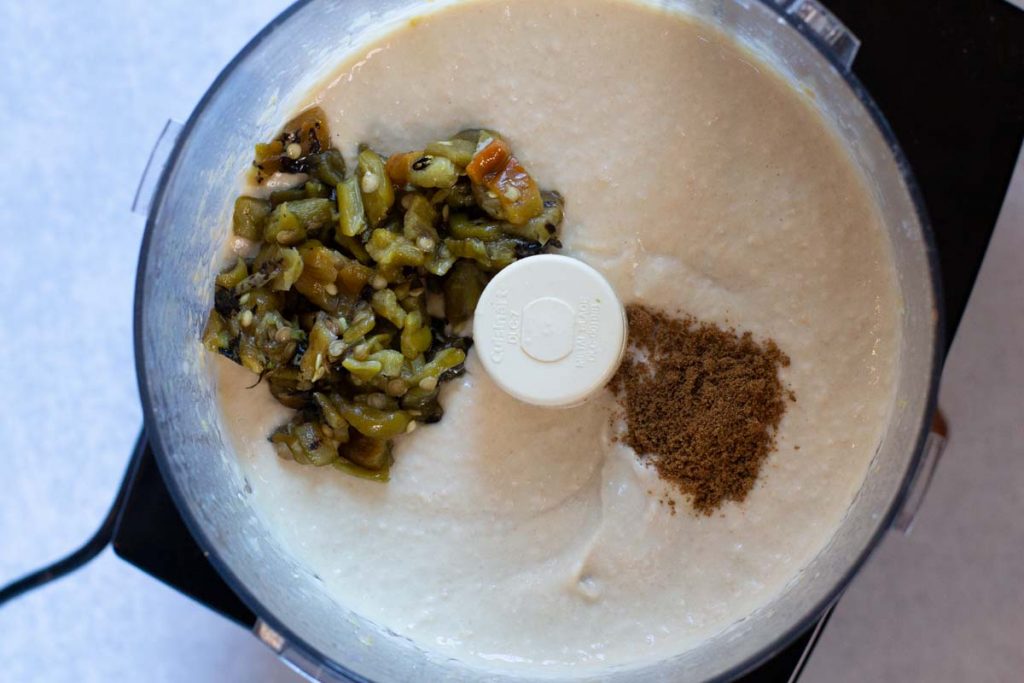Adding cumin powder to make spicy green chile hummus