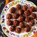 BBQ meatballs displayed on a decorative plate.