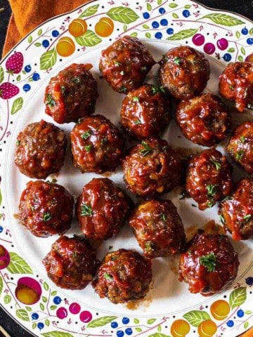 BBQ meatballs displayed on a decorative plate.