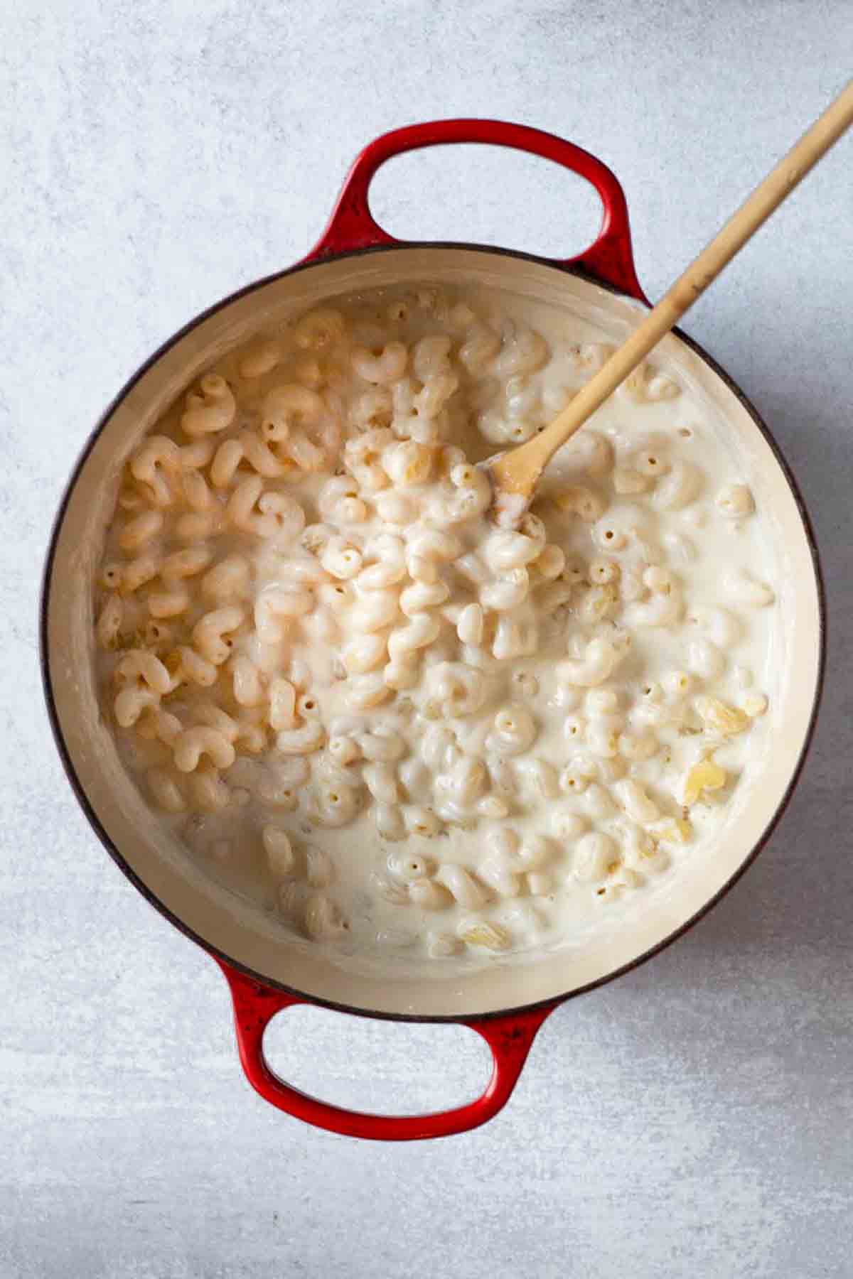 Adding cooked pasta to roux to make flemings steakhouse mac and cheese.