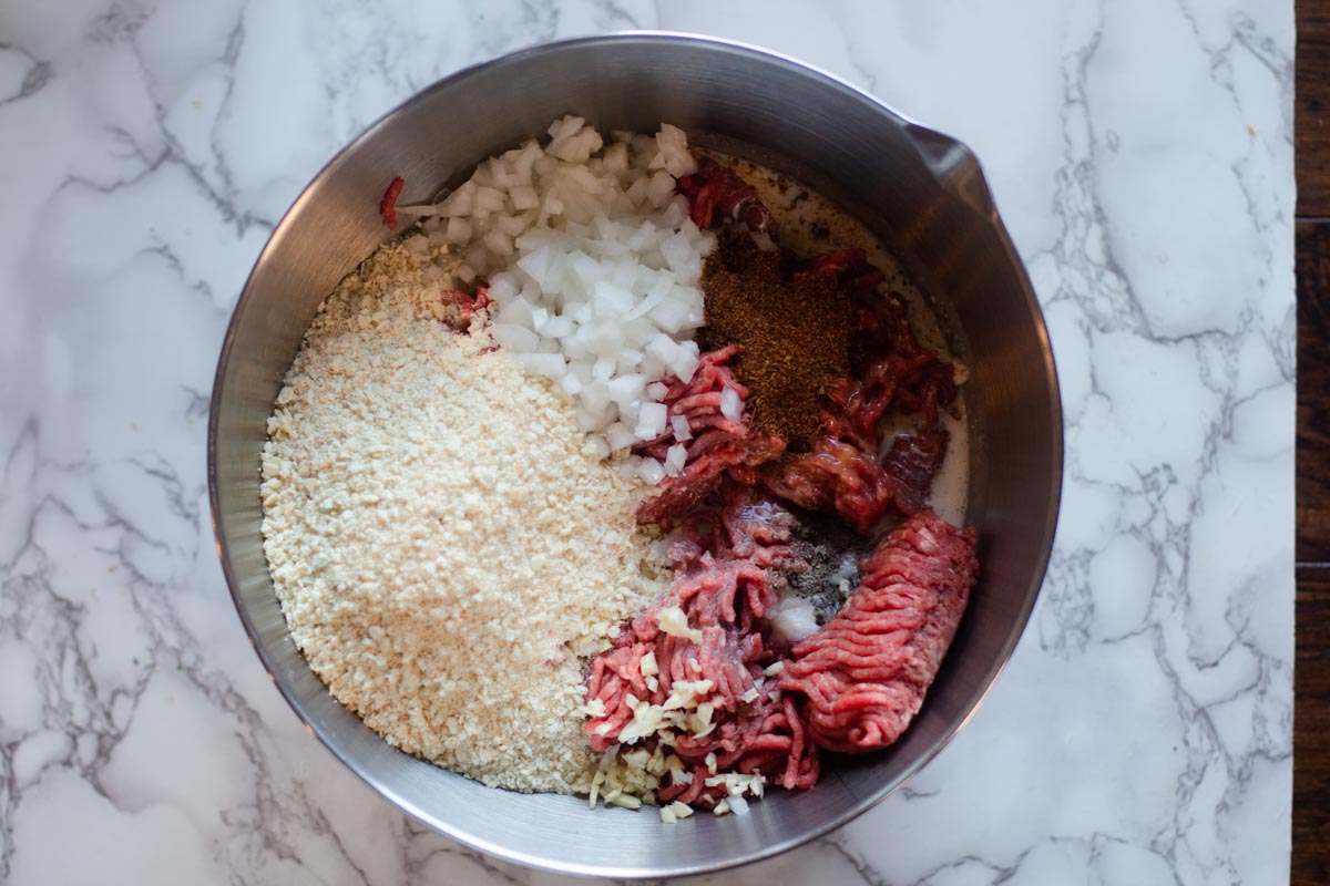 Mixing ingredients together to make homemade BBQ Meatballs
