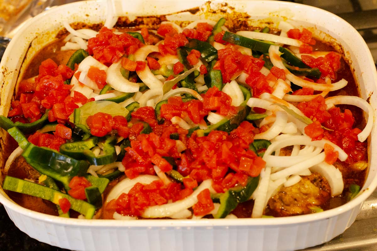 layering the pork and vegetables